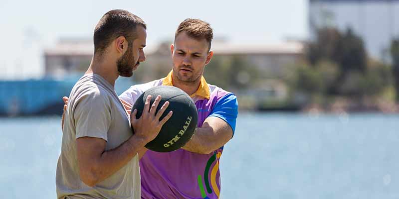 Image of two men using exercise equipment